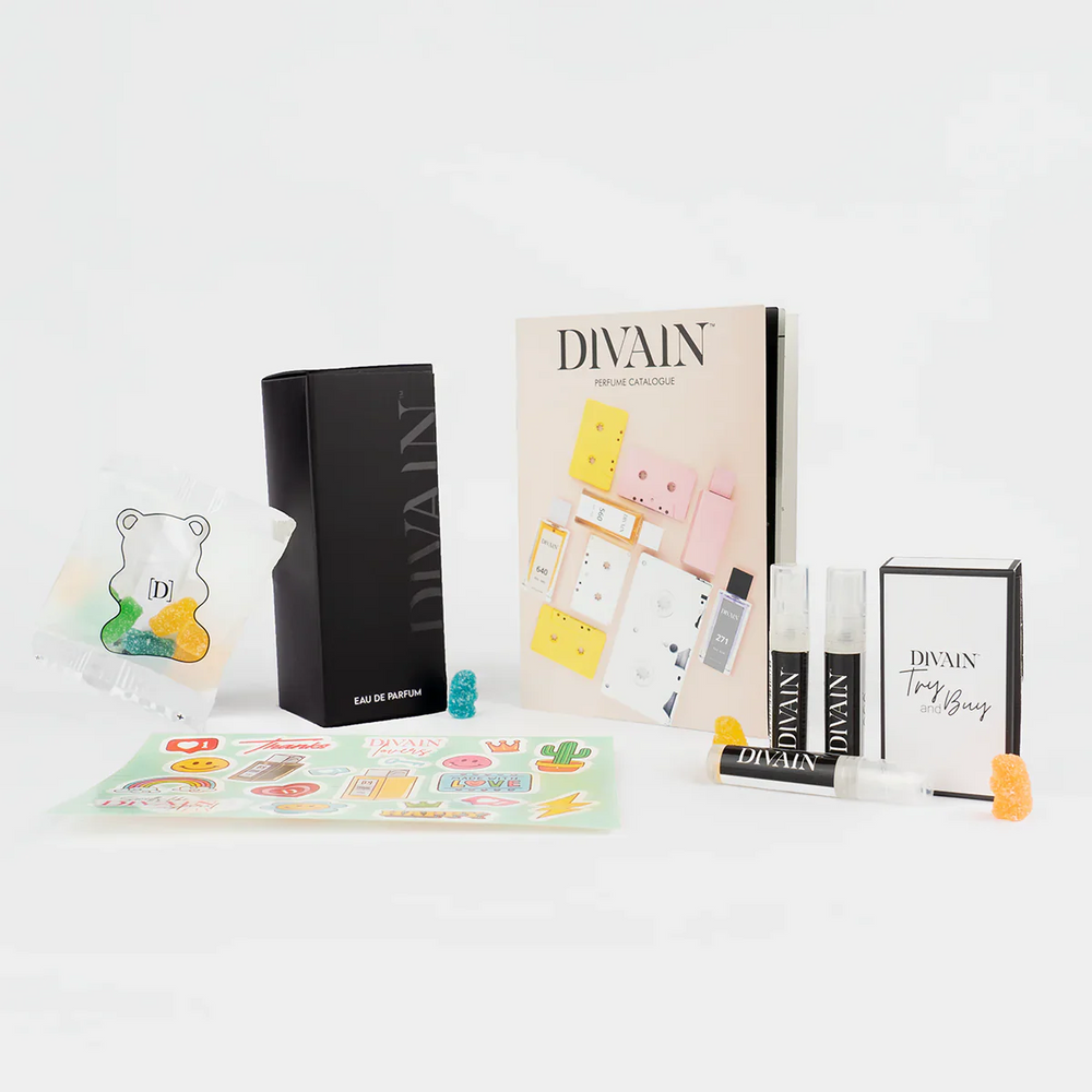 Open divain-pakket met het parfum divain-255, stickers en snoepjes
