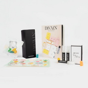 Open divain-pakket met het parfum divain-467, stickers en snoepjes
